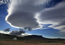 Westfjords farmhouse and dramatic clouds