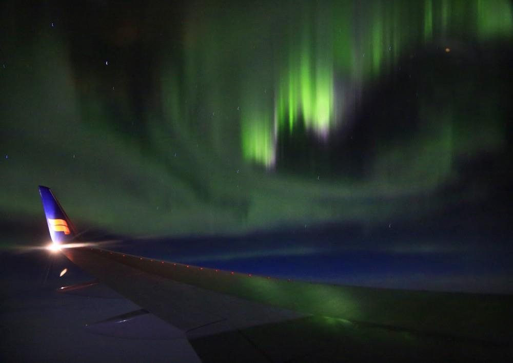 Icelandair flight over the North Atlantic with Aurora Boralis over wing